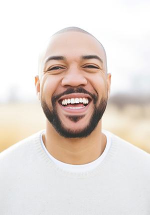 Man in white shirt smiling