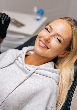 Patient reclined in treatment chair smiling