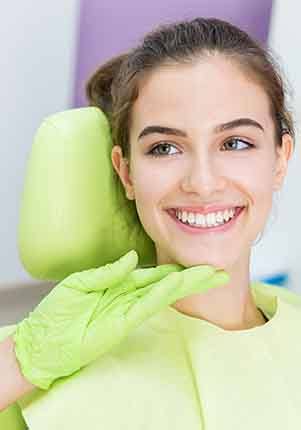 Dentist looking at smiling patient's teeth